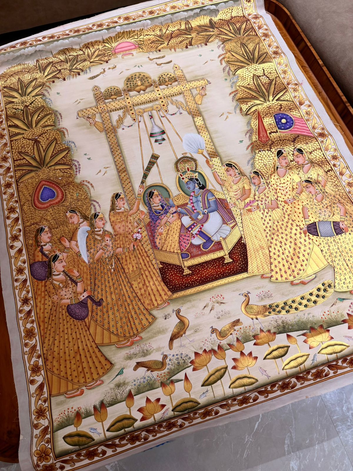 Hand-painted Indian Pichwai artwork showcasing intricate gold detailing and traditional craftsmanship