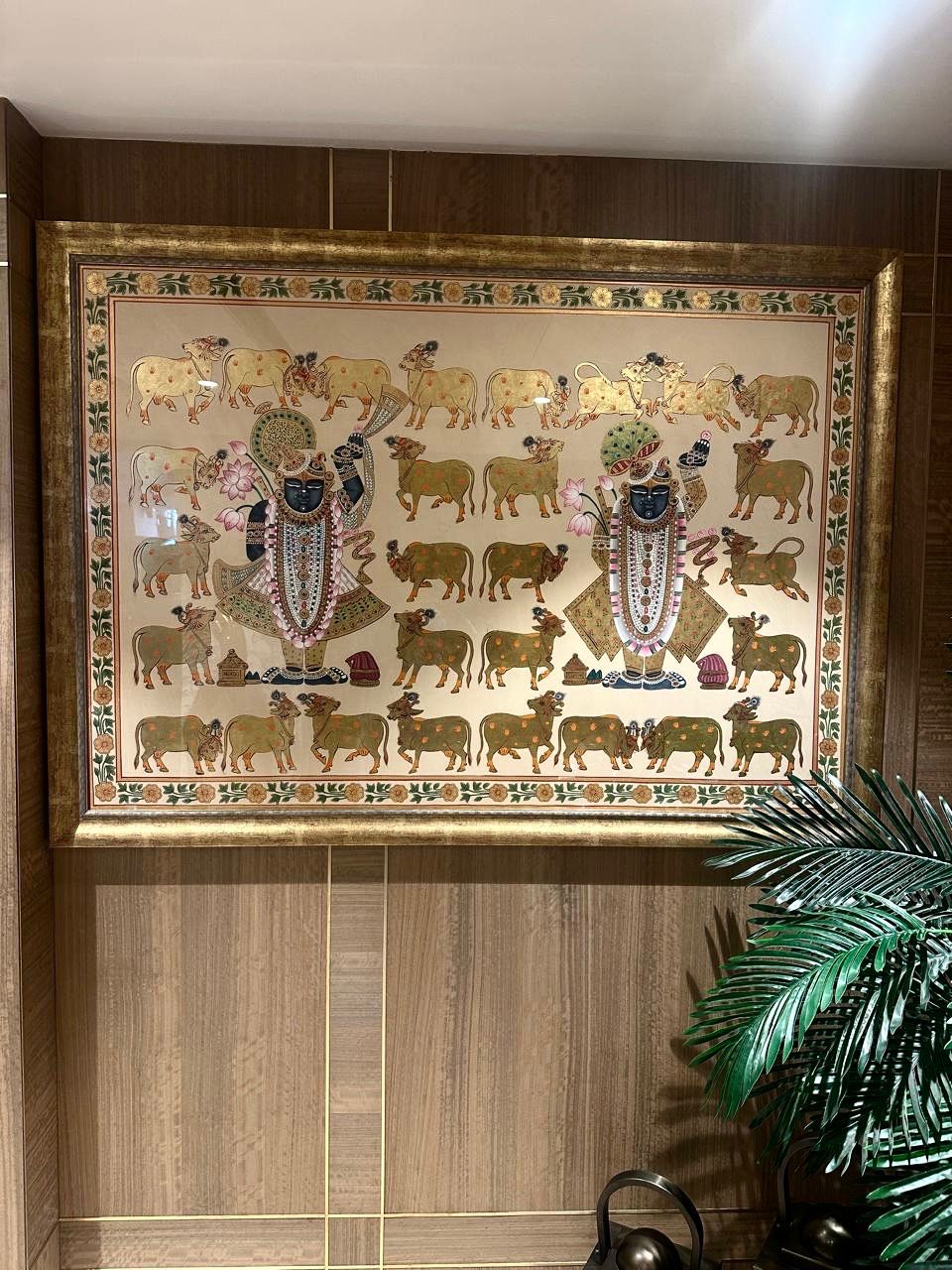 Authentic hand-painted Indian artwork displayed on a wall, highlighting traditional detailing and craftsmanship